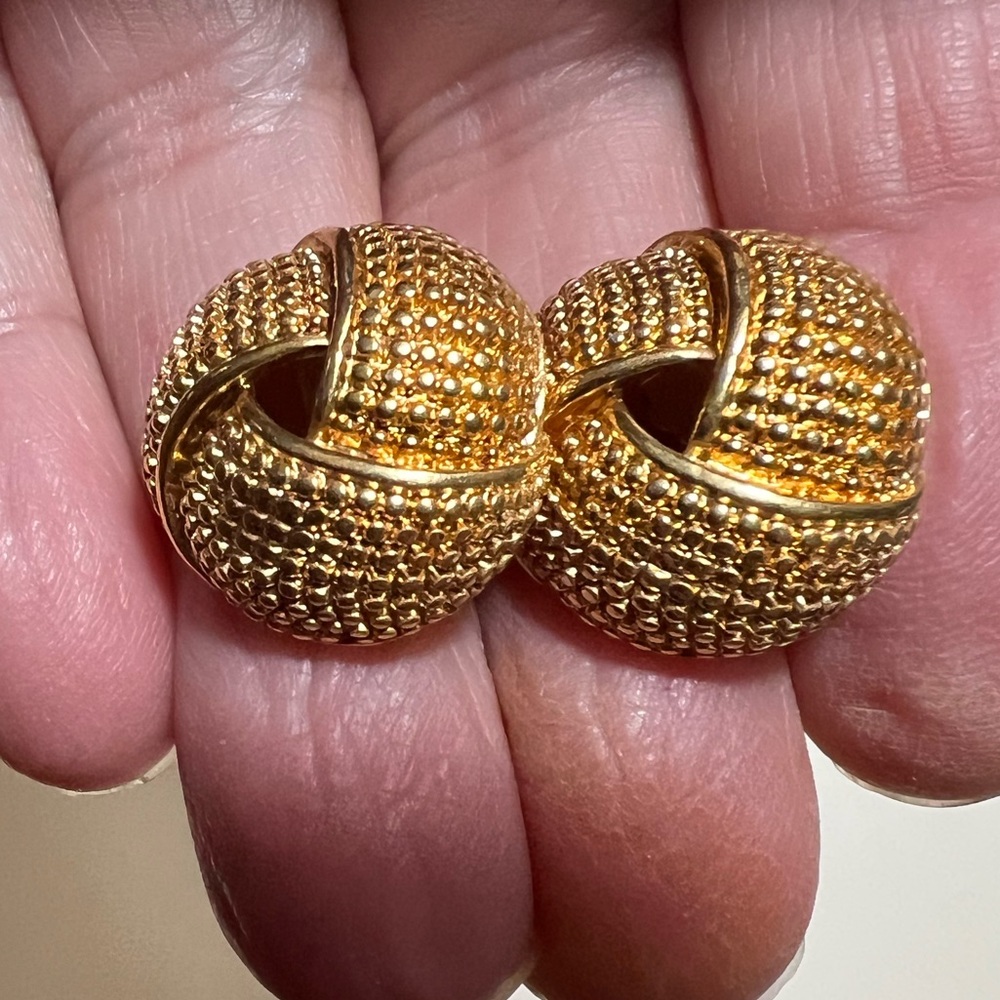 Vintage Avon gold tone textured love knot stud earrings. 1/2” diameter.